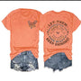 "Let Them" tee in orange.